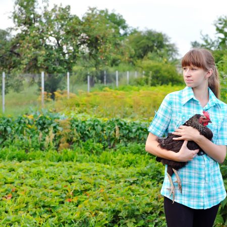 Female Farmer holding chicken